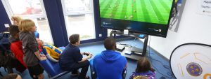 Children playing Shrewsbury Town stars at FIFA playstation