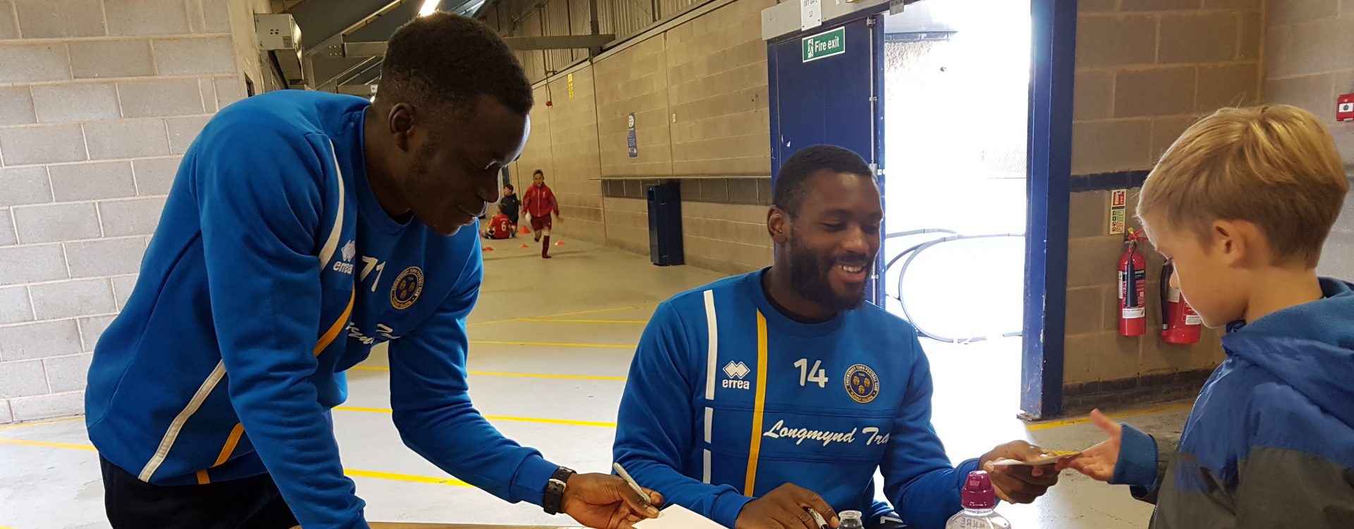 Shrewsbury Town players sign autographs