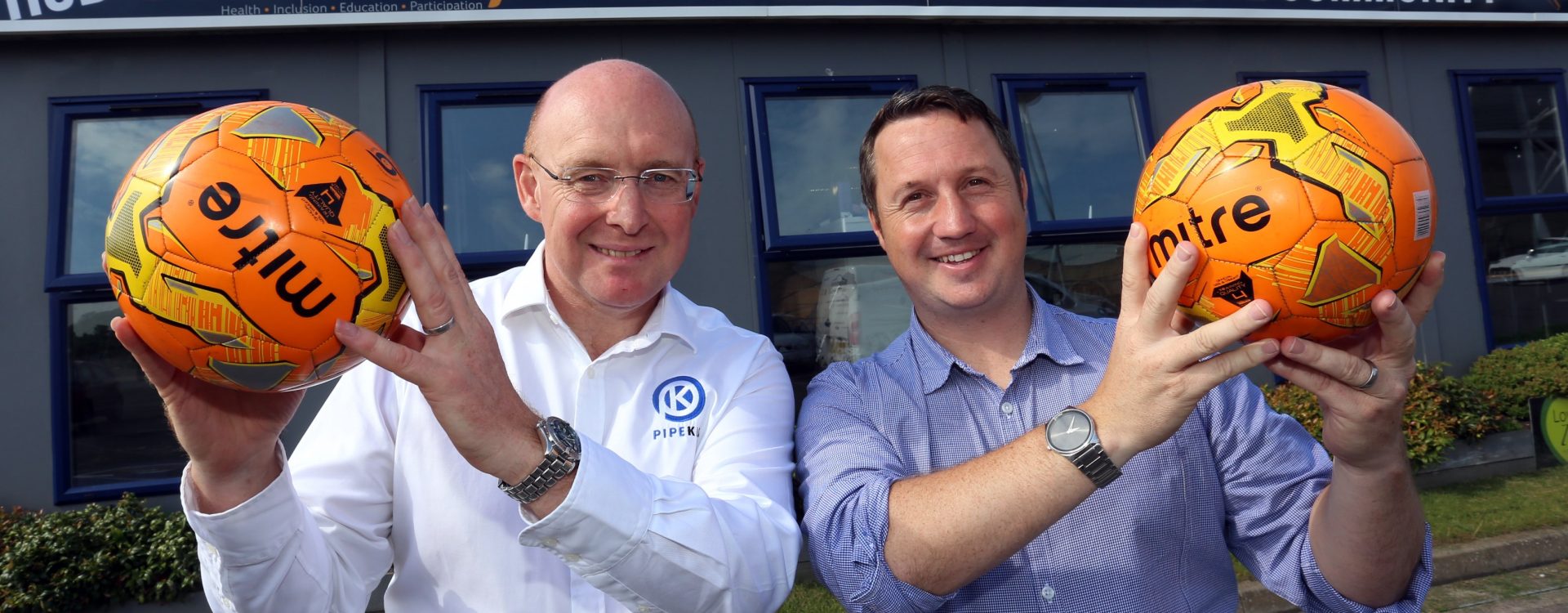 Jamie Edwards, STitC, and Martyn Rowlands, Pipekit pose with footballs