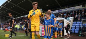 Matchday mascot walks out with Dean Henderson