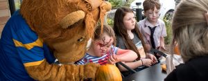 Lenny the Lion helps children carve pumpkins