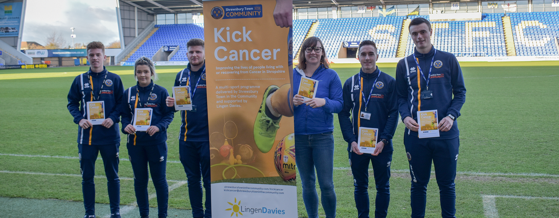 Students and Lingen Davies pose with Kick Cancer banner